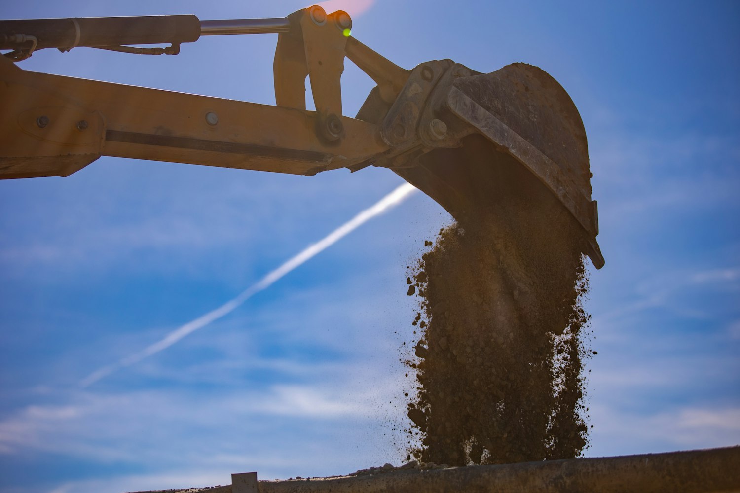 Excavator bucket against blue sky